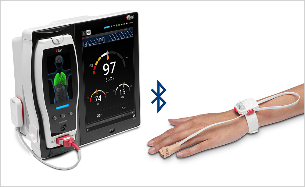 Masimo Root device with hand wearing wearing a Masimo sensor. 